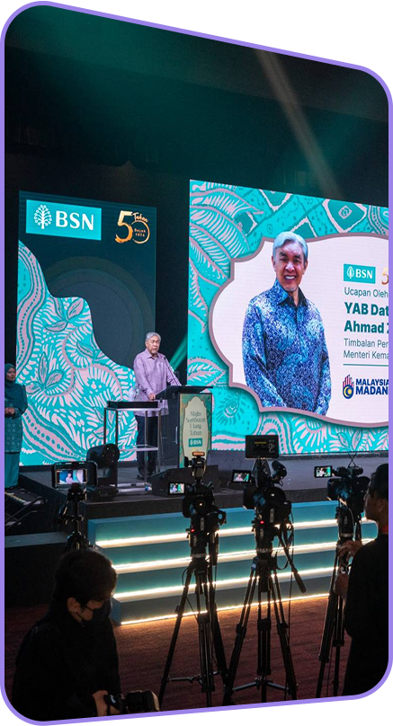 BSN 50th Anniversary event featuring a keynote speech with LED screens displaying branding.